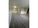 Spacious open-concept living area featuring modern gray laminate flooring and neutral wall colors at 5388 Robertson Path, Lithonia, GA 30038
