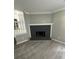 View of the dark colored fireplace in living room with new wood floors at 5388 Robertson Path, Lithonia, GA 30038