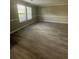 Large living room featuring laminate flooring, a window, and white trim at 5388 Robertson Path, Lithonia, GA 30038