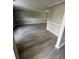 Bright living room with gray laminate flooring, white trim, and neutral gray walls at 5388 Robertson Path, Lithonia, GA 30038