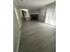 Large living room with fireplace, lots of light, and new grey wood flooring at 5388 Robertson Path, Lithonia, GA 30038