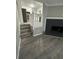 View of the dark colored fireplace in living room with new wood floors at 5388 Robertson Path, Lithonia, GA 30038