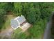 Gorgeous aerial view of a modern farmhouse nestled among mature trees with a circular driveway at 80 Surrey Chase Drive, Social Circle, GA 30025