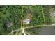 Aerial view of the property with property lines indicated and surrounding trees and ponds at 80 Surrey Chase Drive, Social Circle, GA 30025