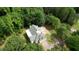 Aerial view of the home showing the driveway, gray roof, and surrounding green trees at 80 Surrey Chase Drive, Social Circle, GA 30025