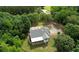 Stunning aerial view of a home nestled within lush greenery with a long driveway at 80 Surrey Chase Drive, Social Circle, GA 30025
