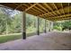 This home features a large, shady back porch that overlooks the trees at 80 Surrey Chase Drive, Social Circle, GA 30025
