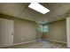 This is an empty basement bedroom with modern flooring and a window overlooking trees at 80 Surrey Chase Drive, Social Circle, GA 30025