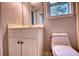 Small bathroom includes a toilet, vanity, and mirror at 80 Surrey Chase Drive, Social Circle, GA 30025