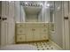 Bathroom with vanity with drawers and cabinets, mirror and black and white patterned floor at 80 Surrey Chase Drive, Social Circle, GA 30025
