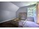 An empty bedroom features a bed frame, carpet, a window, and access to the bathroom at 80 Surrey Chase Drive, Social Circle, GA 30025