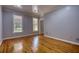 Empty bedroom with hardwood floors, neutral paint, and two windows at 80 Surrey Chase Drive, Social Circle, GA 30025