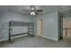 This bedroom includes a bunk bed, showing the door to the hallway, as well as a ceiling fan at 80 Surrey Chase Drive, Social Circle, GA 30025