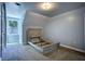 This empty bedroom has gray walls and a window with trees visible at 80 Surrey Chase Drive, Social Circle, GA 30025