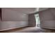 Spacious bedroom with neutral tones, an angled ceiling, and a window for natural light at 80 Surrey Chase Drive, Social Circle, GA 30025