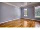 Empty bedroom with hardwood floors, neutral paint, and natural light at 80 Surrey Chase Drive, Social Circle, GA 30025