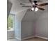 A bedroom showing the unique architecture of the roofline, a ceiling fan and a window at 80 Surrey Chase Drive, Social Circle, GA 30025