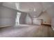 Expansive bonus room with angled ceilings, carpeted floors, and a window providing natural light at 80 Surrey Chase Drive, Social Circle, GA 30025