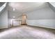 Large bonus room with angled ceilings, carpeted floors, and a staircase with a railing at 80 Surrey Chase Drive, Social Circle, GA 30025