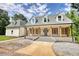 Charming home featuring a spacious front porch with columns and a well-maintained yard at 80 Surrey Chase Drive, Social Circle, GA 30025
