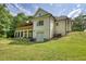 Side view of home and covered deck showing light siding and brick foundation at 80 Surrey Chase Drive, Social Circle, GA 30025