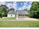 Beautiful home featuring a manicured lawn and traditional architectural style at 80 Surrey Chase Drive, Social Circle, GA 30025
