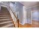 Bright foyer featuring hardwood floors, staircase with white railing, and neutral paint at 80 Surrey Chase Drive, Social Circle, GA 30025