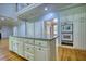 Open kitchen with white cabinets, granite countertops, and a large island at 80 Surrey Chase Drive, Social Circle, GA 30025