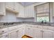 Updated kitchen with granite countertops, modern appliances, and white cabinets at 80 Surrey Chase Drive, Social Circle, GA 30025