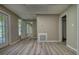 This bright, open living room features wood-look floors and access to the exterior of the house at 80 Surrey Chase Drive, Social Circle, GA 30025