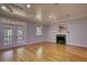 Spacious living room with a fireplace, hardwood floors, and natural light at 80 Surrey Chase Drive, Social Circle, GA 30025