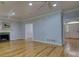 Expansive living room with a fireplace, hardwood floors and archway entry at 80 Surrey Chase Drive, Social Circle, GA 30025