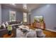 Cozy living room featuring a comfortable couch, hardwood floors, and stylish decor at 80 Surrey Chase Drive, Social Circle, GA 30025