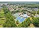 A stunning aerial view showing the community pool, tennis courts, playground, and several houses at 1099 Sandy Bank Ct, Auburn, GA 30011