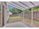 Fenced backyard featuring a covered patio and a view of the surrounding trees at 1099 Sandy Bank Ct, Auburn, GA 30011