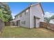 View of the home's gray siding, and level, fenced backyard, complete with a patio, perfect for outdoor living at 1099 Sandy Bank Ct, Auburn, GA 30011