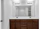 Bathroom featuring a double vanity with dark cabinets at 1099 Sandy Bank Ct, Auburn, GA 30011