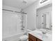 Well-lit bathroom featuring a shower-tub combo, vanity with sink, and contemporary fixtures for a clean aesthetic at 1099 Sandy Bank Ct, Auburn, GA 30011