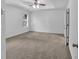 Spacious bedroom with neutral carpet, tray ceiling, and modern ceiling fan at 1099 Sandy Bank Ct, Auburn, GA 30011