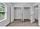 Bright bedroom featuring large closets, a window offering natural light, and neutral carpet flooring at 1099 Sandy Bank Ct, Auburn, GA 30011