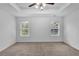 Bright bedroom with plush carpeting, and a modern ceiling fan fixture at 1099 Sandy Bank Ct, Auburn, GA 30011