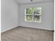 Cozy bedroom featuring carpet flooring, white walls, and a window offering natural light at 1099 Sandy Bank Ct, Auburn, GA 30011