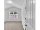 Bright bedroom featuring vaulted ceiling, neutral carpet, and a window offering natural light at 1099 Sandy Bank Ct, Auburn, GA 30011