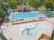 Aerial view of a sparkling community pool and splash pad surrounded by plenty of lounge chairs at 1099 Sandy Bank Ct, Auburn, GA 30011