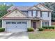Charming two-story home with a well-manicured front yard and two-car garage, perfect for Gathering living at 1099 Sandy Bank Ct, Auburn, GA 30011