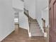Inviting foyer with staircase and wood-look flooring, providing a warm welcome at 1099 Sandy Bank Ct, Auburn, GA 30011
