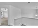 Bright hallway featuring carpet flooring, white walls, and a modern lighting fixture at 1099 Sandy Bank Ct, Auburn, GA 30011