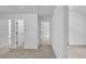 Hallway with neutral carpet, white doors, and ample natural light, offering a clean and bright space at 1099 Sandy Bank Ct, Auburn, GA 30011