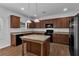 Well-equipped kitchen with island, granite countertops, stainless steel appliances, and ample cabinet space at 1099 Sandy Bank Ct, Auburn, GA 30011