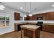 Stylish kitchen featuring granite countertops, an island, dark cabinets, and stainless steel appliances at 1099 Sandy Bank Ct, Auburn, GA 30011